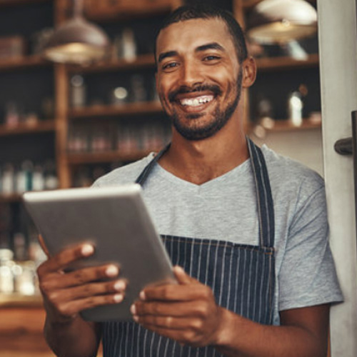 Man smiling and using tablet