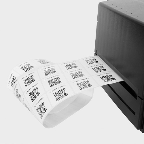 Stickers with QR codes on them coming out of printer