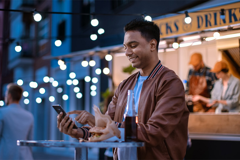 Man smiling and using his phone