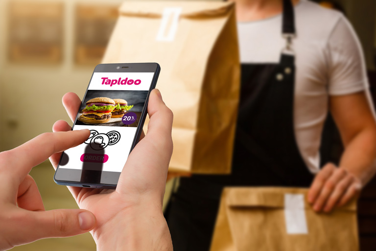 Person scrolling through the Tapldoo online food ordering system on their phone